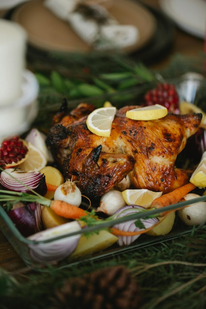 pexels-photo-6210747-6210747 Delicious roast chicken surrounded by fresh vegetables, perfect for a holiday feast.